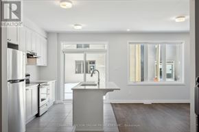 Ottawa townhouse for rent - A modern kitchen with white appliances and cabinets.