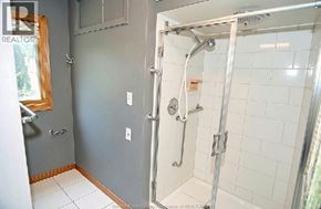 Windsor apartment for rent - A bathroom with a walk-in shower and a window.