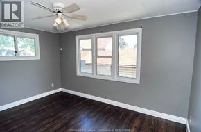 Windsor apartment for rent - A room with a ceiling fan and a window with blinds.
