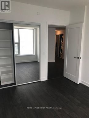 Toronto (Waterfront Communities) condo for rent - A room with a sliding door and a white wall.