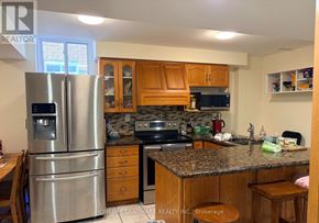 Mississauga (Central Erin Mills) apartment for rent - A kitchen with a refrigerator, sink, and cabinets.
