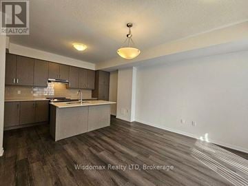 Vaughan (Vaughan Corporate Centre) townhouse for rent - A kitchen with brown cabinets and a wooden floor.