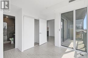 Toronto (Wychwood) condo for rent - A white room with a glass door leading to a balcony.