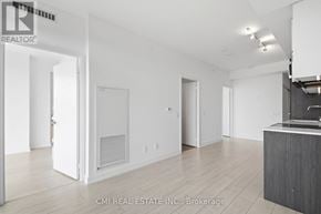 Toronto (Wychwood) condo for rent - A real estate company is showcasing an empty living space.