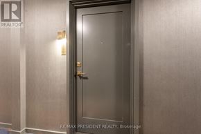 Toronto (Church-Yonge Corridor) condo for rent - A closed door with a handle and a small light on the wall.