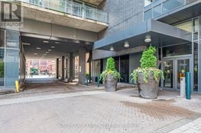 Toronto (Waterfront Communities) condo for rent - A building entrance with a glass door and a sign that says "REALTOR".