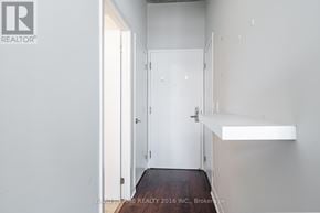 Toronto (Waterfront Communities) condo for rent - A hallway with a door on the left and a light on the right.