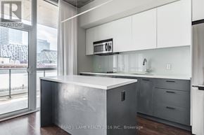 Toronto (Waterfront Communities) condo for rent - A modern kitchen with a large island and stainless steel appliances.