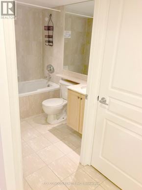 Toronto (Waterfront Communities) condo for rent - A white bathroom with a toilet, sink and tub.