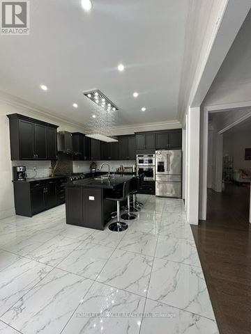 Brampton (Toronto Gore Rural Estate) apartment for rent - A modern kitchen with black cabinets and a marble floor.