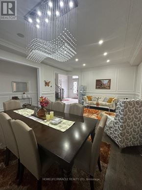 Brampton (Toronto Gore Rural Estate) apartment for rent - A well-lit dining room with a large table and chairs.