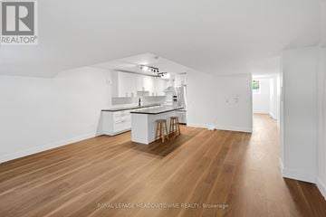Brampton (Northwest Brampton) apartment for rent - A kitchen with white cabinets and a wooden floor.