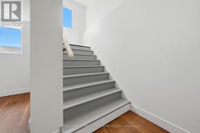 Brampton (Northwest Brampton) apartment for rent - A staircase in a room with a logo on the wall.