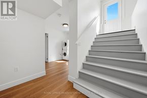Brampton (Northwest Brampton) apartment for rent - A staircase with a white door at the top.