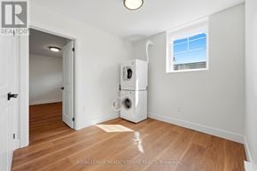Brampton (Northwest Brampton) apartment for rent - A white washer and dryer in a room with wood flooring and a window.