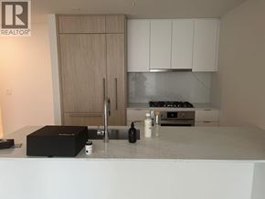 Coquitlam apartment for rent - A kitchen with a white countertop and wooden cabinets.