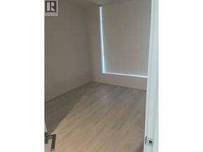 Coquitlam apartment for rent - A room with a wooden floor and a white door.