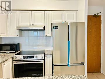 Toronto (Willowdale West) condo for rent - A kitchen with white cabinets and a black microwave above the stove.