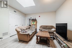Toronto (East End-Danforth) apartment for rent - A living room with a couch, chair, and television.