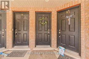 Guelph (Victoria North) townhouse for rent - Three doors with wreaths and garlands on them.