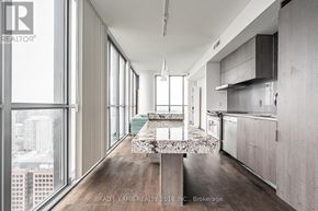 Toronto (Church-Yonge Corridor) condo for rent - A modern kitchen with a marble island in the middle.