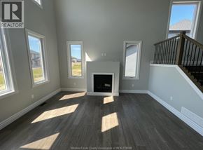 Amherstburg apartment for rent - A large, empty room with a fireplace and wooden flooring.