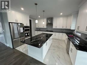 Amherstburg apartment for rent - A kitchen with black countertops and white cabinets.