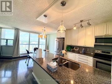 London East (East E) condo for rent - A kitchen with granite countertops and stainless steel appliances.