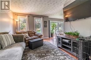 Niagara Falls (West Wood) apartment for rent - A living room with a grey couch and a black coffee table.