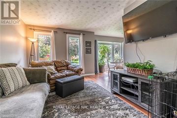 Niagara Falls (West Wood) apartment for rent - A living room with a grey couch and a black coffee table.