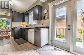 Niagara Falls (West Wood) apartment for rent - A kitchen with a white fridge and black cabinets.