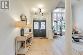 Burlington (Rose) apartment for rent - A well-lit, spacious living room with a wooden table and a mirror on the wall.