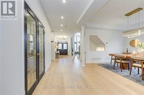 Burlington (Rose) apartment for rent - A spacious room with a dining table set up with chairs and a vase of flowers.