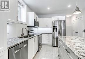 Azilda apartment for rent - A modern kitchen with granite countertops and stainless steel appliances.