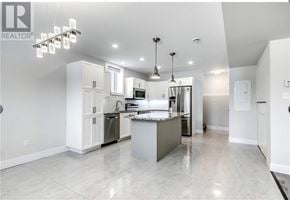 Azilda apartment for rent - A modern kitchen with a marble countertop and stainless steel appliances.