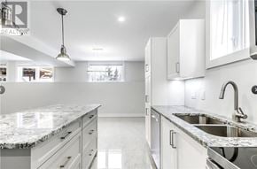 Azilda apartment for rent - A modern kitchen with granite countertops and stainless steel appliances.