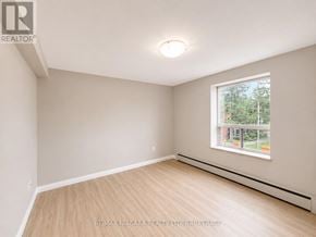 St. Catharines (Downtown) multi-family for rent - A room with a window and a wooden floor.