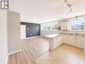St. Catharines (E. Chester) multi-family for rent - A kitchen with white cabinets and a large island.