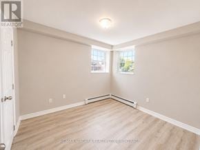 St. Catharines (E. Chester) multi-family for rent - A room with a white door, a window, and a light on the ceiling.