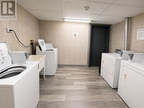 St. Catharines (E. Chester) multi-family for rent - A brokerage office with two desks and a printer.