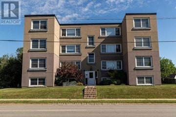 St. Catharines (E. Chester) multi-family for rent - A multi-story residential building with a blue sky in the background.