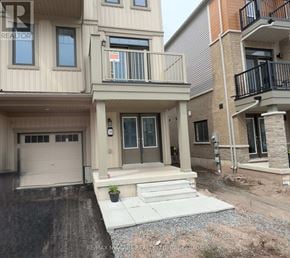 Welland (Dain City) townhouse for rent - A two-story residential building with a garage and a balcony.