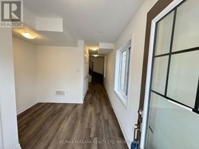 Welland (Dain City) townhouse for rent - A hallway with wood flooring and white walls.