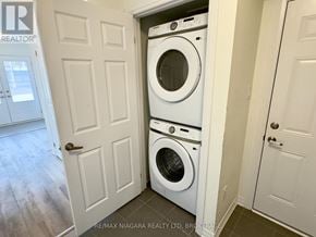 Welland (Dain City) townhouse for rent - A white door is open to reveal a white washer and dryer.