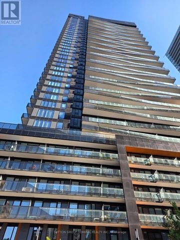 Toronto (Mount Pleasant West) condo for rent - A tall building with many windows and balconies is shown in the image.