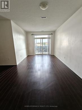Markham (Cedarwood) condo for rent - A room with wooden floors and a large window.