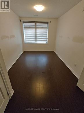 Markham (Cedarwood) condo for rent - A room with wooden floors and a window with blinds.
