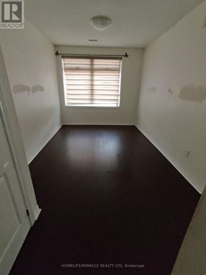 Markham (Cedarwood) condo for rent - A room with a window and a wooden floor.