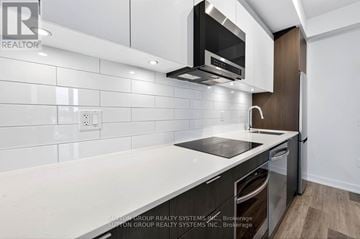 Toronto (Stonegate-Queensway) condo for rent - A modern kitchen with a stainless steel oven and microwave above the stove.