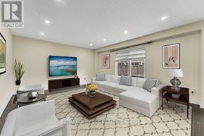 Brantford apartment for rent - A living room with a white couch, a coffee table, and a painting on the wall.